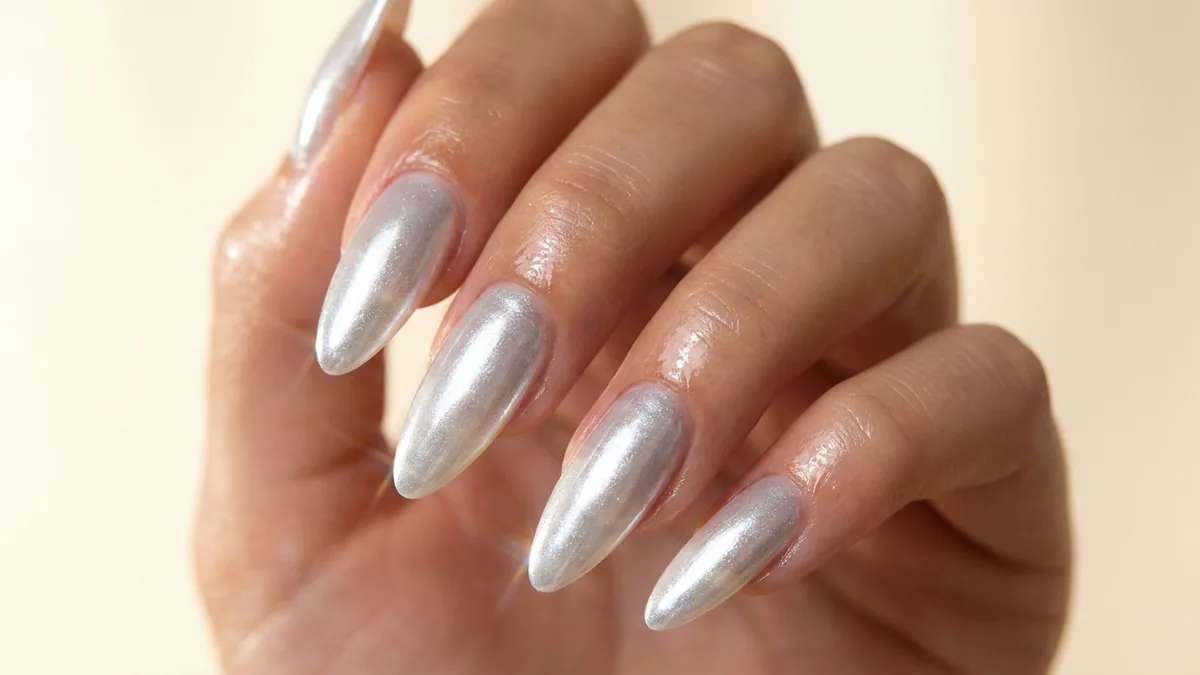 Close-up of glossy chrome pearlescent glazed-donut finish nails with iridescent shimmer