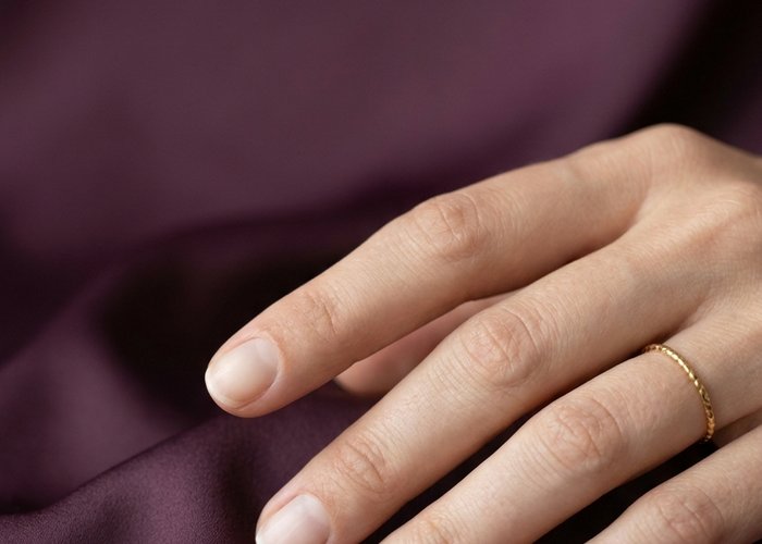 Close-up of short, neatly filed natural nails with a healthy, glossy finish