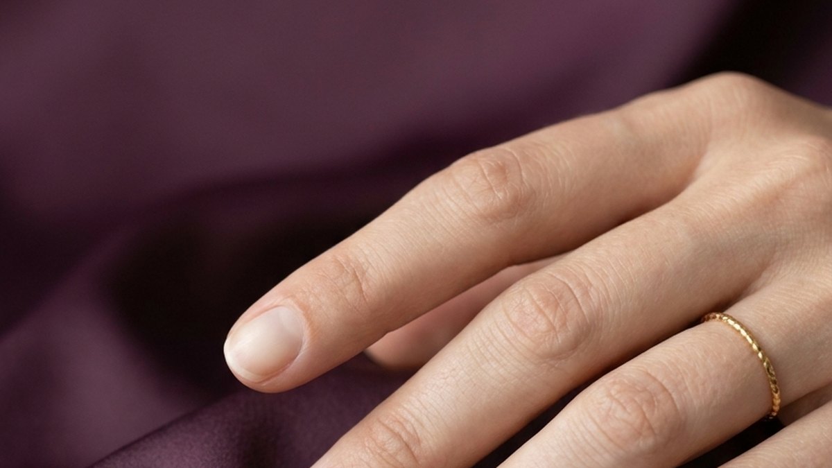 Close-up of short, neatly filed natural nails with a healthy, glossy finish